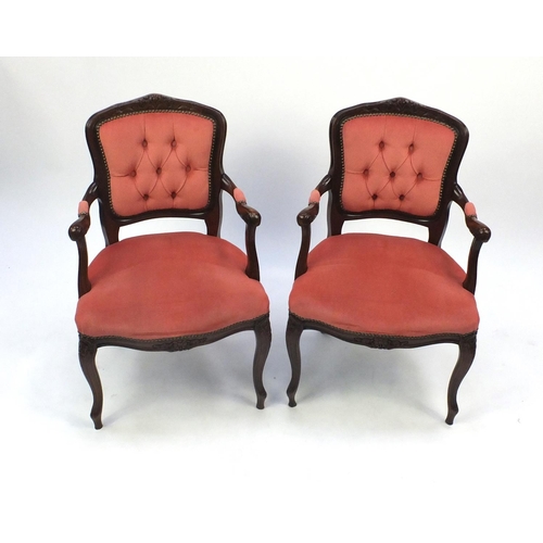 10 - Pair of French design carved mahogany open arm chairs, with pink buttonback upholstery