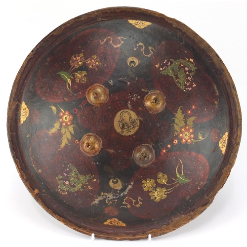 607 - Circular Islamic leather shield, hand painted with flowers, 33cm in diameter