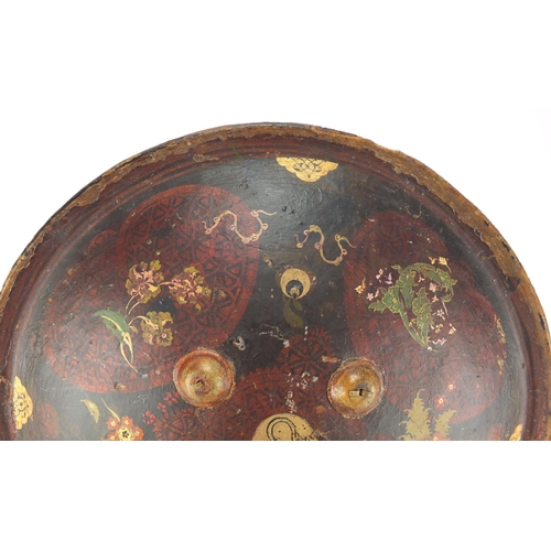 607 - Circular Islamic leather shield, hand painted with flowers, 33cm in diameter