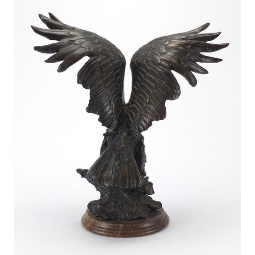 2251 - Bronzed study of a bald eagle on a circular stepped marble base, 42cm high