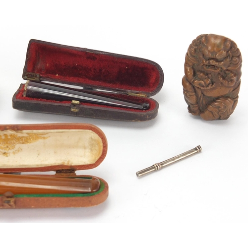 33 - Antique and later objects including two amber coloured cheroots with fitted leather cases, four vest... 