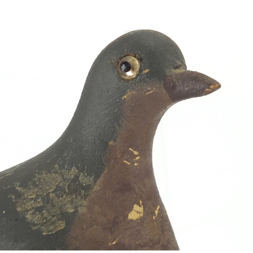 94 - Two antique hand painted carved wood pigeons decoys, one with beaded glass eyes, each 29cm in length