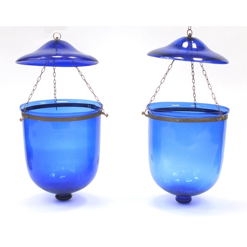 767 - Two 19th century Bristol Blue glass hanging pendants, with star motifs, the largest approximately 40... 