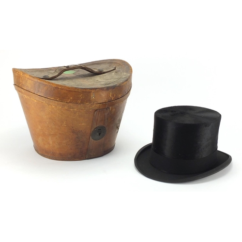 101 - McLaren of Glasgow top hat with a fitted tan leather hat box, size 6