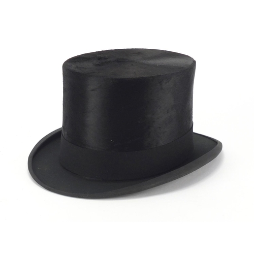 101 - McLaren of Glasgow top hat with a fitted tan leather hat box, size 6