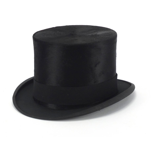 101 - McLaren of Glasgow top hat with a fitted tan leather hat box, size 6