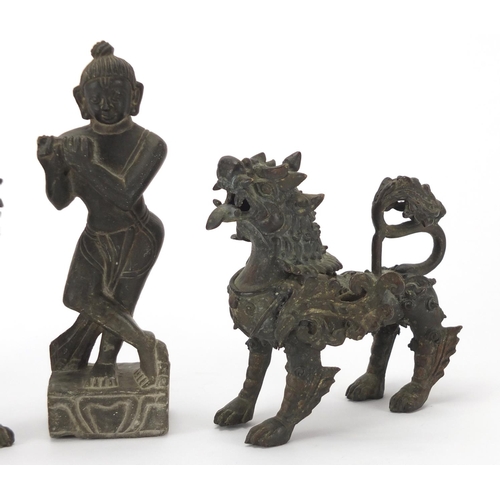 2272 - Two Oriental bronze dragons and a carved stone figure, the largest 17cm high