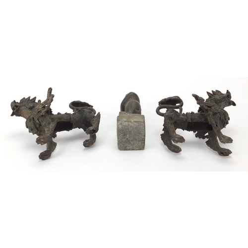 2272 - Two Oriental bronze dragons and a carved stone figure, the largest 17cm high