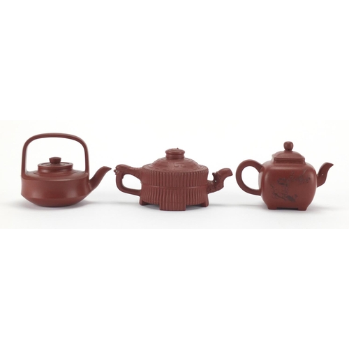 2266 - Three Chinese Yixing terracotta teapots, one with calligraphy, character marks to the base, the larg... 