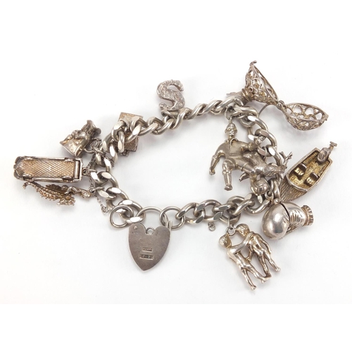 2793 - Silver charm bracelet with selection of mostly silver charms, including football player, Toby jug, s... 