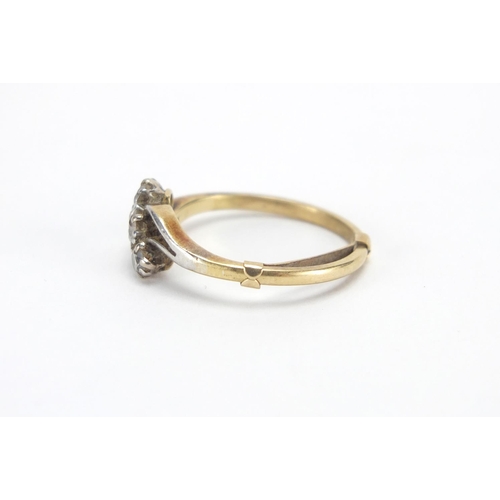 2603 - Unmarked gold clear stone crossover ring, size L, approximate weight 2.5g