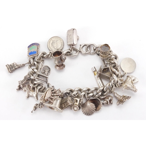 2711 - Silver charm bracelet with selection of mostly silver charms, including spinning wheel, horse and ca... 