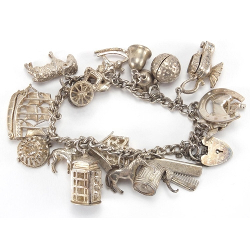 2802 - Silver charm bracelet with a selection of silver charms including carriage, telephone box and animal... 