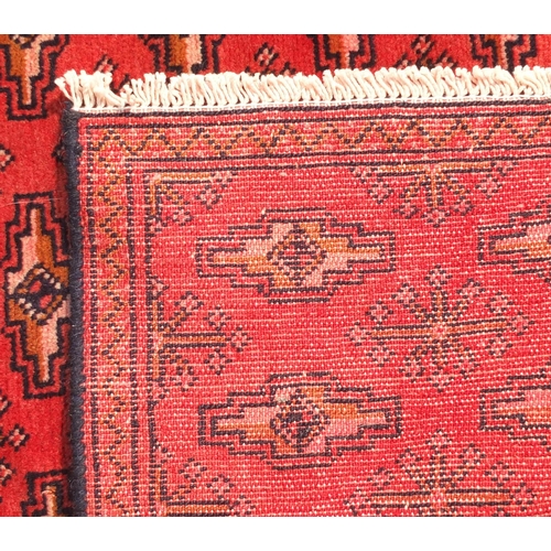 2078 - Rectangular Turkman carpet runner, having an all over repeat gull design onto a red ground, 332cm x ... 