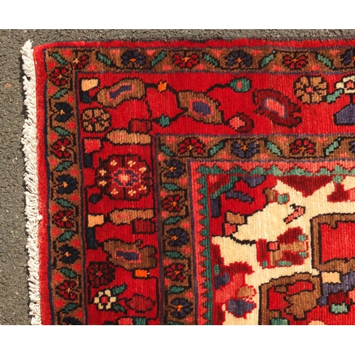 2009 - Rectangular Hamadan rug, having an all over stylised floral design onto a predominantly red and blac... 