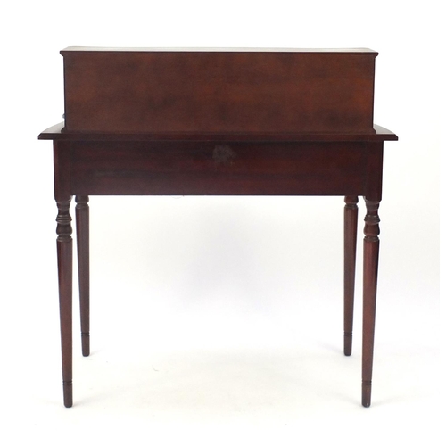 25 - Mahogany serpentine front ladies writing desk, with tooled leather insert and a series of drawers, 9... 