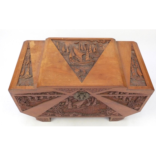 24 - Oriental camphorwood trunk, carved with figures on boats, 60cm H x 100cm W x 50cm D
