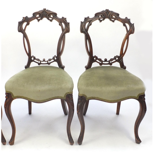 23 - Set of four Victorian carved mahogany chairs, with green stuffover seats