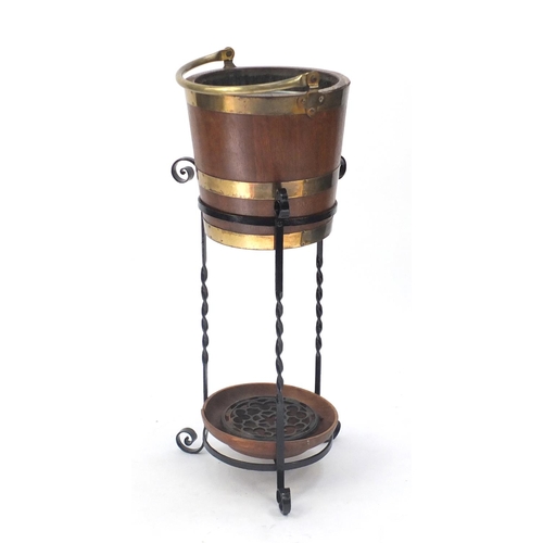 13 - Brass bound oak barrel on stand, 86cm high excluding the handle