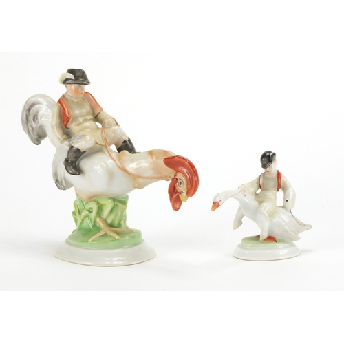 2449 - Two Herend of Hungary hand painted porcelain models of boys on birds, the largest 14cm high