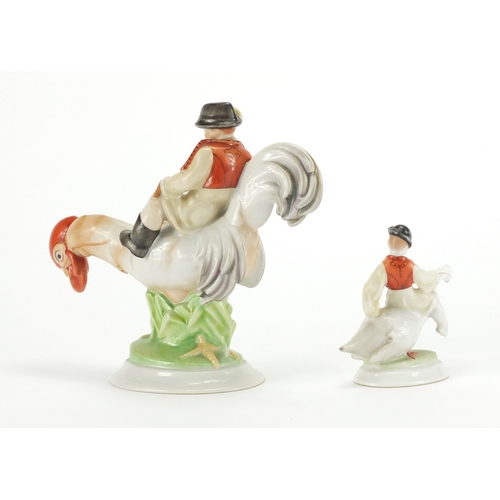 2449 - Two Herend of Hungary hand painted porcelain models of boys on birds, the largest 14cm high