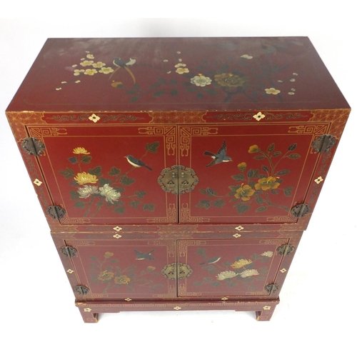 6 - Oriental red lacquered four door cupboard, hand painted with birds and flowers, 123cm H x 91cm W x 4... 