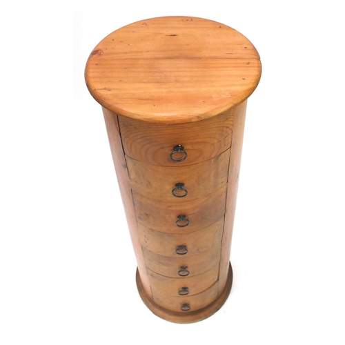 7 - Cylindrical pine seven drawer chest, 121cm high x 45cm in diameter