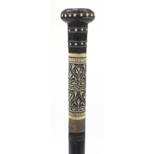 106 - Indian carved ebony and bone sword stick with steel blade, 91cm in length