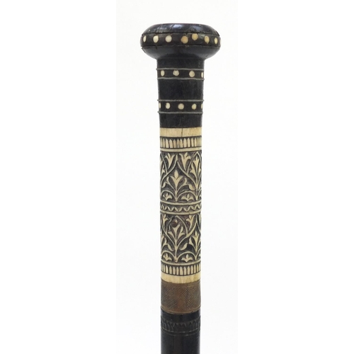 106 - Indian carved ebony and bone sword stick with steel blade, 91cm in length