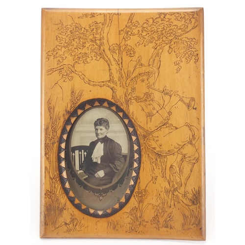 64 - Victorian rectangular easel pokerwork frame, decorated with the Pied Piper beside a tree, 27cm x 19c... 