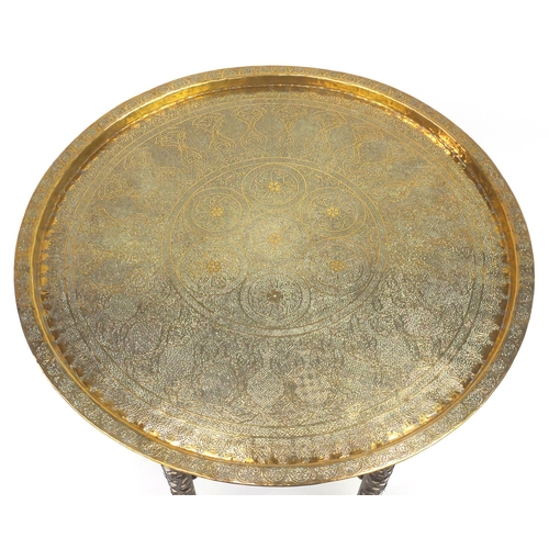 581 - Good Cairoware tray finely engraved with script and foliate motifs, the folding hardwood base with m... 