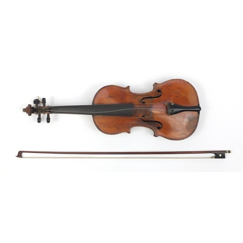 131 - Old wooden violin with scrolled neck, bow and fitted carrying case, the violin back 15 inches in len... 