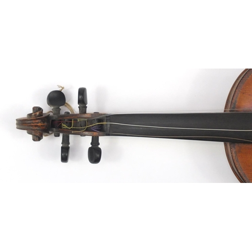 131 - Old wooden violin with scrolled neck, bow and fitted carrying case, the violin back 15 inches in len... 