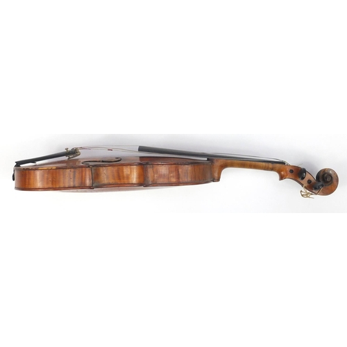 131 - Old wooden violin with scrolled neck, bow and fitted carrying case, the violin back 15 inches in len... 