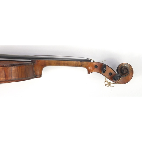 131 - Old wooden violin with scrolled neck, bow and fitted carrying case, the violin back 15 inches in len... 