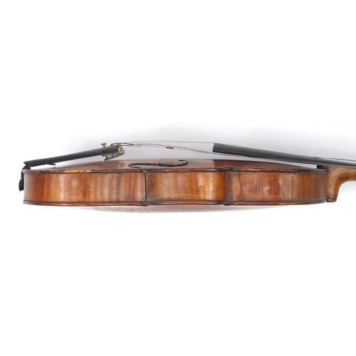 131 - Old wooden violin with scrolled neck, bow and fitted carrying case, the violin back 15 inches in len... 