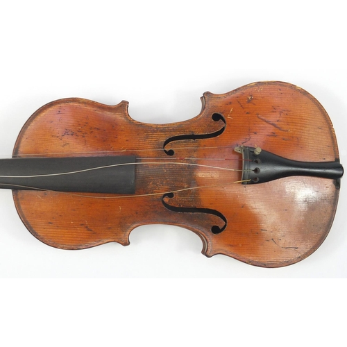 131 - Old wooden violin with scrolled neck, bow and fitted carrying case, the violin back 15 inches in len... 