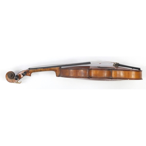 131 - Old wooden violin with scrolled neck, bow and fitted carrying case, the violin back 15 inches in len... 