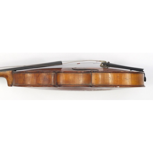 131 - Old wooden violin with scrolled neck, bow and fitted carrying case, the violin back 15 inches in len... 