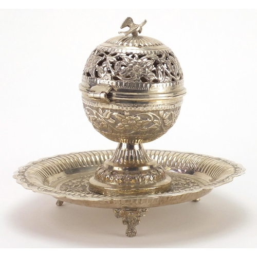 590 - Islamic unmarked silver three footed incense burner, pierced and embossed with flower heads amongst ... 
