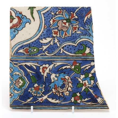 594 - Iznik pottery tile fragment, hand painted with stylised flowers, 20cm x 19cm