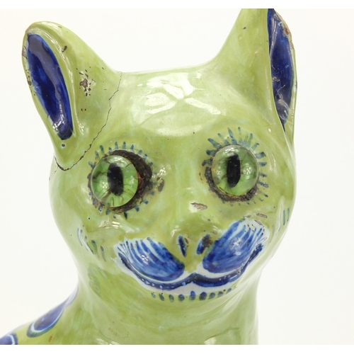 816 - Galle style pottery model of a seated cat, with heart motifs, painted marks to the inside, 33cm high