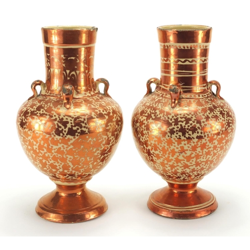 595 - Pair of Middle Eastern lustre pottery vases, hand painted with stylised motifs, each 25cm high