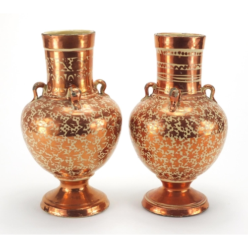 595 - Pair of Middle Eastern lustre pottery vases, hand painted with stylised motifs, each 25cm high