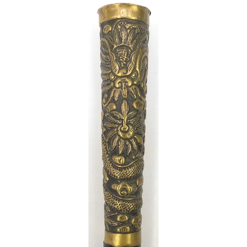 105 - Black painted metal swordstick with brass handle embossed with a Chinese dragon, 89.5cm in length