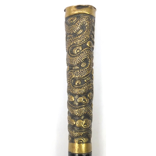 105 - Black painted metal swordstick with brass handle embossed with a Chinese dragon, 89.5cm in length