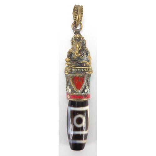 609 - Tibetan brass and stone pendant set with coral and turquoise, 8cm in length