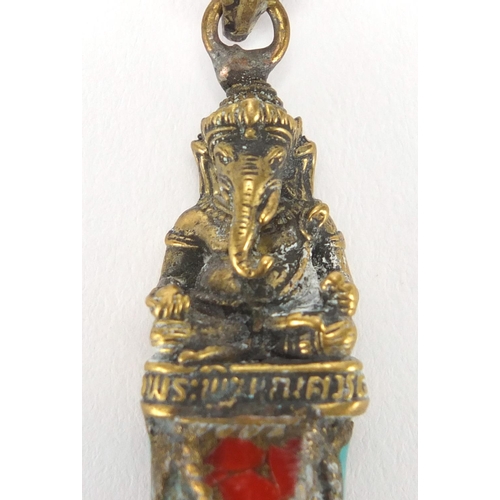 609 - Tibetan brass and stone pendant set with coral and turquoise, 8cm in length