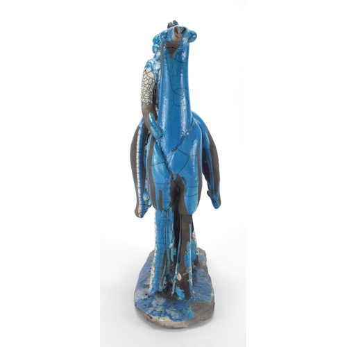 600 - Middle Eastern blue glazed pottery study of a figure on horseback, 42cm high