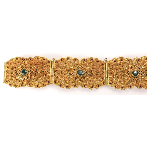 592 - Persian gilt metal filigree wedding belt, set with green and red faceted cabochons, 108cm in length